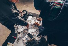 Food Supply UNDER ATTACK From New Threat Two individuals handling stacks of money on a table.