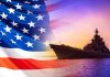 U.S. Navy Gets “Trump Class” Battleships American flag overlaying warship at sunset.