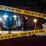 Yellow police tape in front of crime scene.