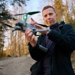 Drone Steak Drop EXPOSES Shocking Prison Chaos Person holding a drone in a forest.