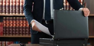 Gavel, lawyer, briefcase, and legal books on the table.