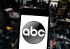 Late Night Host Attacks Trump and Loses His Platform A smartphone displaying the ABC logo against an urban backdrop