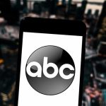 Late Night Host Attacks Trump and Loses His Platform A smartphone displaying the ABC logo against an urban backdrop