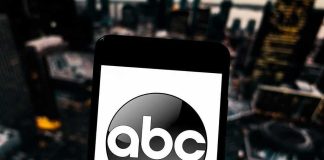 Late Night Host Attacks Trump and Loses His Platform A smartphone displaying the ABC logo against an urban backdrop
