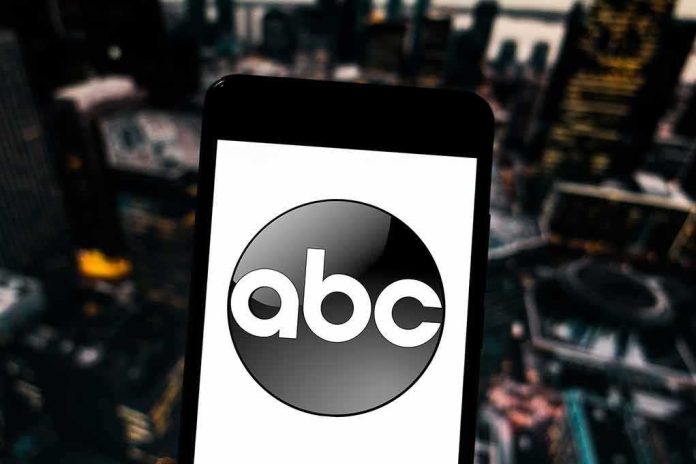 A smartphone displaying the ABC logo against an urban backdrop