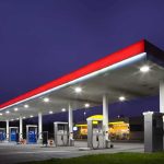 Mob Looting ERUPTS — Soft-Crime Policies Backfire A gas station at night with illuminated fuel pumps and a convenience store