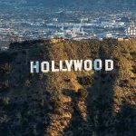 High-Profile Guest DIES Suddenly The Hollywood sign on a hillside.