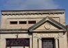 Stone building facade with bank sign and columns
