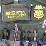Americans Caught In ICE Raids Border Patrol vest with gear and communication equipment.