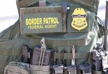 Americans Caught In ICE Raids Border Patrol vest with gear and communication equipment.