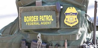 Americans Caught In ICE Raids Border Patrol vest with gear and communication equipment.