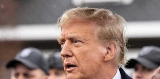 Trump’s ‘Board of Peace’ Threatens UN Man in suit and red tie speaking outside.