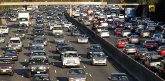 New Mileage Tax Sparks Fears Heavy traffic on a multi-lane highway.