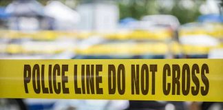 After 20 Years A Murder Case Finally Broke Open Yellow police line tape with Do Not Cross.