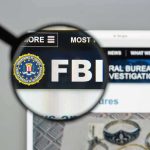 FBI Scrambles: Malicious AI Attack SPREADING FBI website shown through magnifying glass.