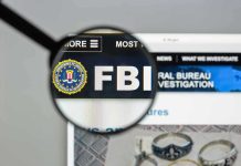 FBI Scrambles: Malicious AI Attack SPREADING FBI website shown through magnifying glass.