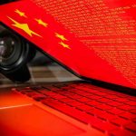 Laptop screen displaying Chinese flag and code.