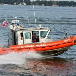 Coast Guard boat speeding on the water.