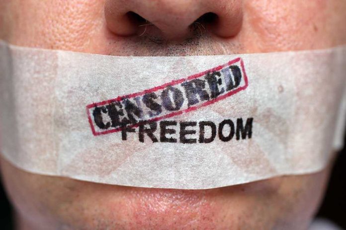 shutterstock_232962532.jpg Close-up of a persons mouth covered with tape that reads CENSORED FREEDOM
