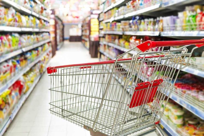 171787895 Empty shopping cart in grocery store aisle.