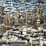 Room filled with various firearms and ammunition belts.