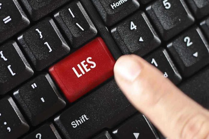 Finger pressing LIES key on keyboard.