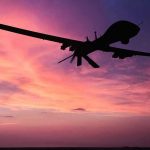 GLOBAL TRADE SHOCK: Black Sea Tensions Escalate Silhouette of a drone against a colorful sunset.