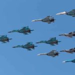 A formation of military jet fighters flying in a clear blue sky