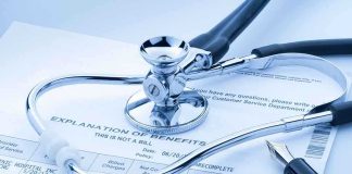 A stethoscope resting on a medical billing statement