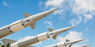 China’s Missile? U.S. Jet Downed Multiple missiles pointed upward on launchers against blue sky.