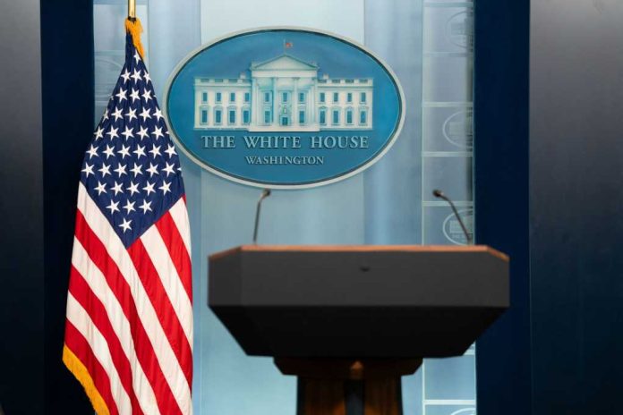 Podium with microphones in front of the White House seal and an American flag