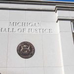 Records Fight Explodes Around Benson Michigan Hall of Justice exterior wall with state seal