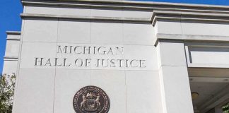 Records Fight Explodes Around Benson Michigan Hall of Justice exterior wall with state seal