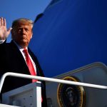 Emoluments Alarm Over Trump’s New Ride A political figure waving while standing on the steps of an aircraft