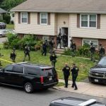 Basement Bust After Family Massacre Law enforcement officers conducting a raid in a residential neighborhood