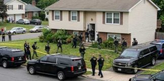 Basement Bust After Family Massacre Law enforcement officers conducting a raid in a residential neighborhood