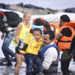 Flood Alerts Blared — Families Still Trapped man in life vest carrying a child from a boat landing