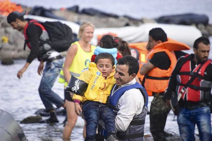 shutterstock_320039453 man in life vest carrying a child from a boat landing