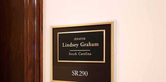 The Senator Who Wants Washington Back in the Abortion Fight office wall plaque with black and gold nameplate and room number