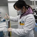 The Brain Detox Everyone’s Talking About Scientist in lab coat using a pipette