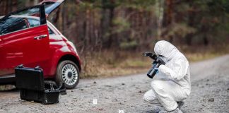 Father-Son Ambush Near Mt. Shasta Forensic investigator photographing evidence near a red car on a rural road