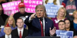 Federal Judge Slaps Trump Voting Order politician speaking at a rally podium