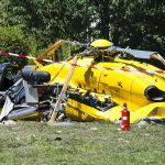 Midair Chaos Over Carlisle Stuns Investigators yellow helicopter crash scene on grassy field