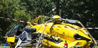 Midair Chaos Over Carlisle Stuns Investigators yellow helicopter crash scene on grassy field