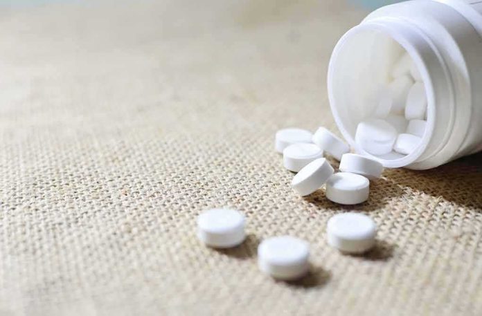shutterstock_1138934090 White tablets spilling from a plastic bottle