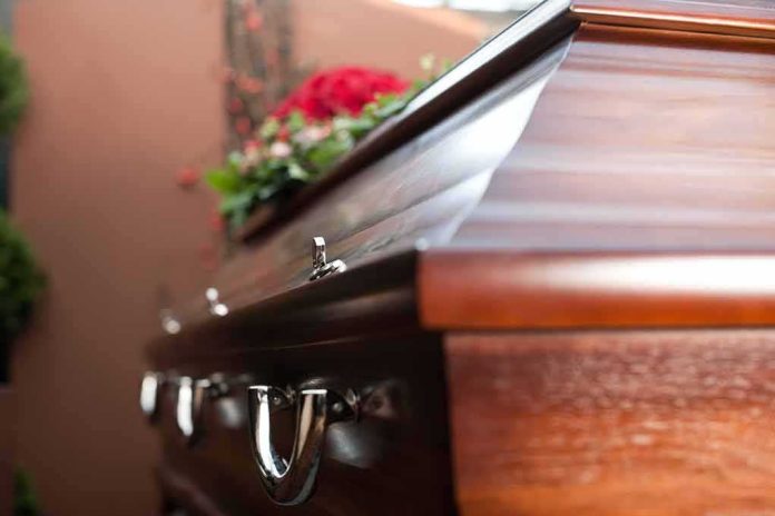 shutterstock_113984350 Wooden casket with floral arrangement