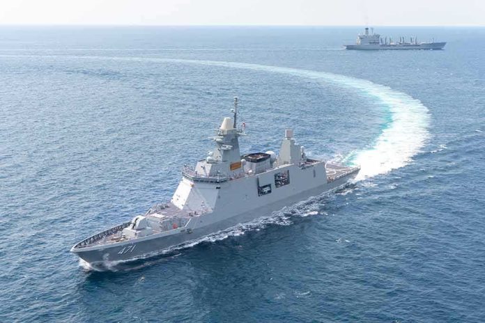 naval warship making a sharp turn at sea