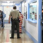 Courtroom Meth Shock Stuns Ex-Frontrunner Corrections officers escort an inmate in a jail hallway