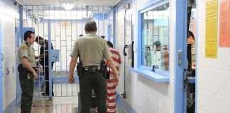 Courtroom Meth Shock Stuns Ex-Frontrunner Corrections officers escort an inmate in a jail hallway
