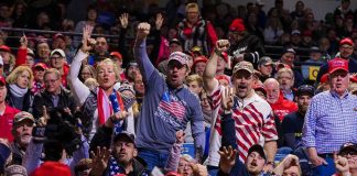 Kremlin Playbook Targets France 2027 Crowd of supporters cheering at an indoor political rally